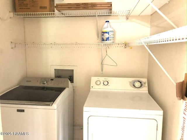 clothes washing area featuring laundry area and washer and clothes dryer