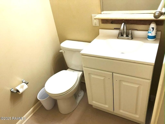 half bathroom featuring baseboards, toilet, vanity, and tile patterned flooring