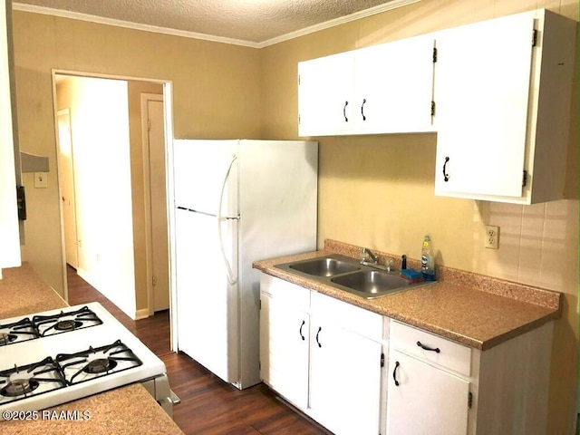 kitchen featuring a sink, white appliances, dark wood-style floors, and white cabinetry