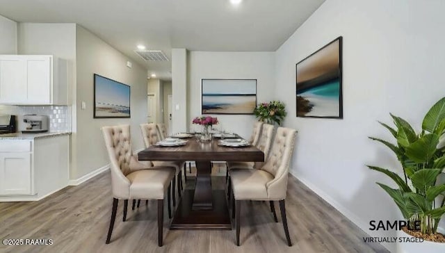 dining space with visible vents, baseboards, and light wood-style floors