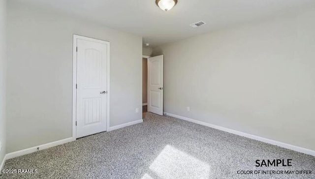 unfurnished bedroom featuring visible vents, baseboards, and carpet flooring