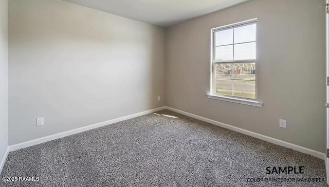 spare room featuring baseboards and carpet