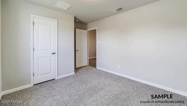 unfurnished bedroom featuring visible vents, baseboards, and carpet