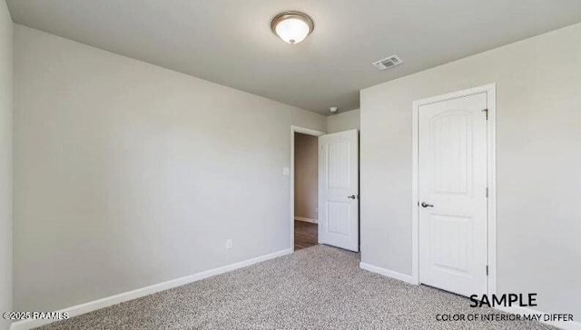 unfurnished bedroom featuring visible vents, light colored carpet, and baseboards