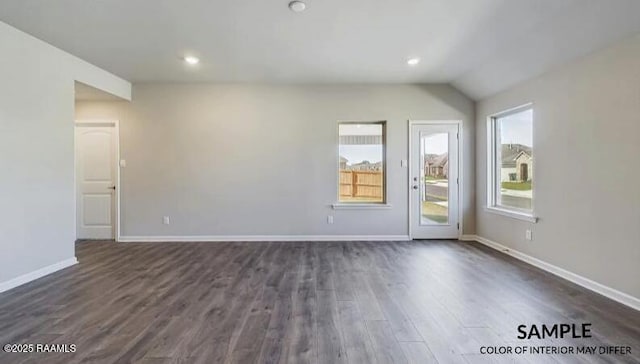 empty room featuring recessed lighting, baseboards, lofted ceiling, and dark wood-style flooring