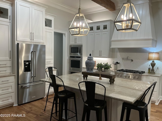 kitchen with a notable chandelier, stainless steel appliances, glass insert cabinets, and ornamental molding