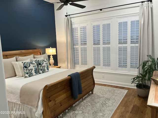 bedroom featuring wood finished floors and ceiling fan