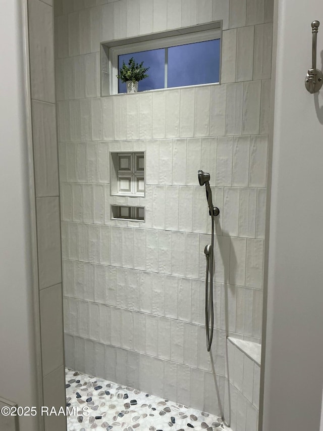 bathroom with tiled shower