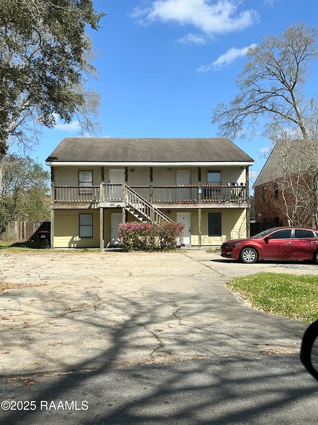 view of front of property featuring driveway and stairs