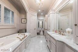 bathroom with a garden tub, ornamental molding, recessed lighting, tile patterned floors, and vanity