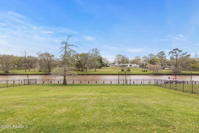 306 Princeton Woods Loop, Lafayette, LA 70508 - view of yard featuring a water view and fence