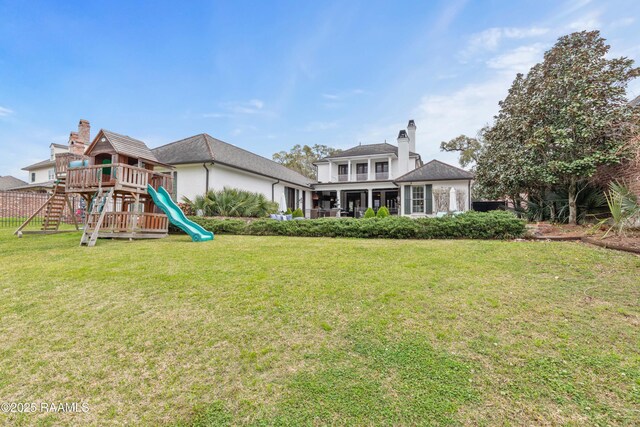 306 Princeton Woods Loop, Lafayette, LA 70508 - back of house featuring a lawn, a chimney, and a playground