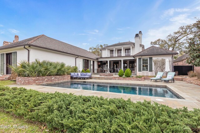 306 Princeton Woods Loop, Lafayette, LA 70508 - back of property featuring a balcony, an outdoor pool, a chimney, a patio area, and an outdoor hangout area