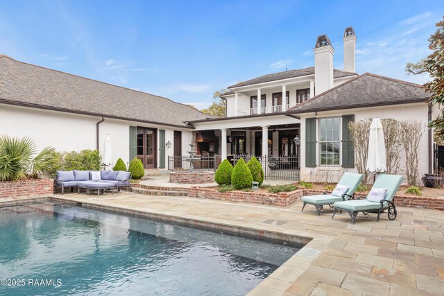 306 Princeton Woods Loop, Lafayette, LA 70508 - rear view of house with a chimney, outdoor lounge area, a balcony, a patio area, and an outdoor pool