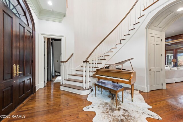 306 Princeton Woods Loop, Lafayette, LA 70508 - entrance foyer with stairway, crown molding, a high ceiling, and hardwood / wood-style floors