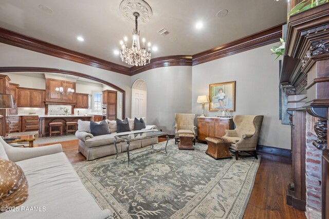 306 Princeton Woods Loop, Lafayette, LA 70508 - living area with visible vents, arched walkways, an inviting chandelier, light wood finished floors, and baseboards