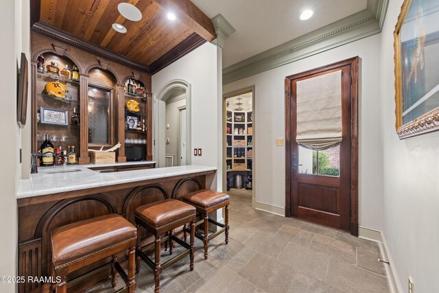 306 Princeton Woods Loop, Lafayette, LA 70508 - bar with ornamental molding, a sink, a bar, baseboards, and wood ceiling