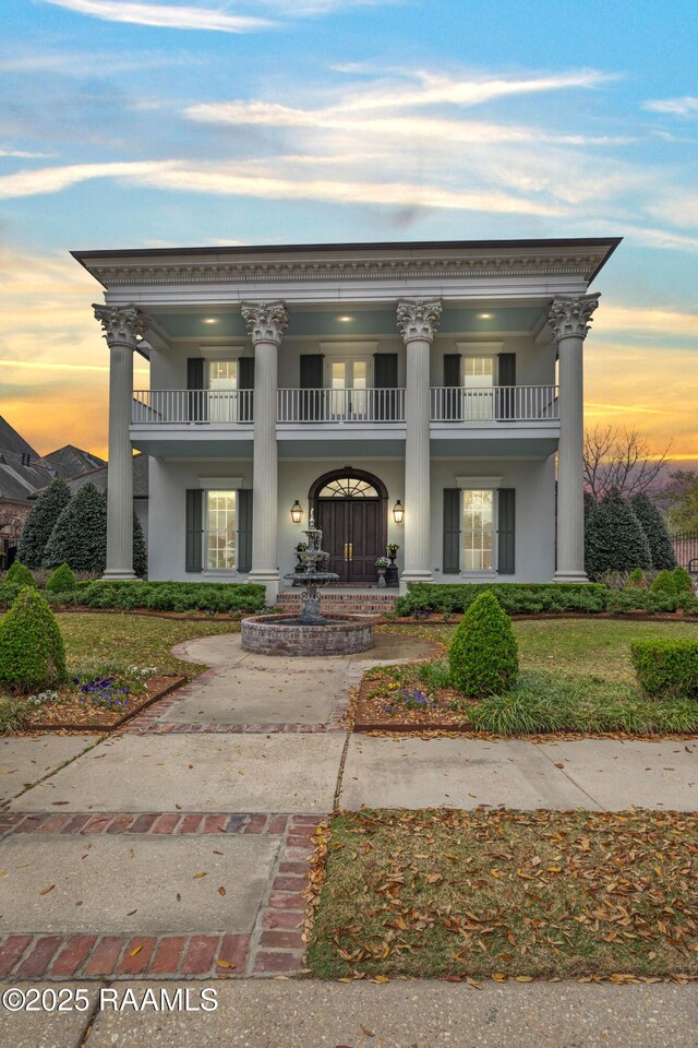 306 Princeton Woods Loop, Lafayette, LA 70508 - greek revival house with stucco siding and a balcony
