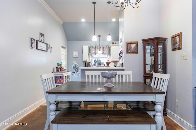 dining area with vaulted ceiling and baseboards