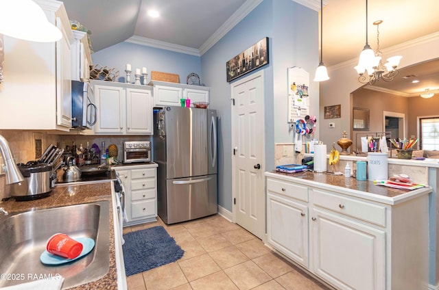 kitchen featuring ornamental molding, a sink, white cabinetry, appliances with stainless steel finishes, and light tile patterned flooring