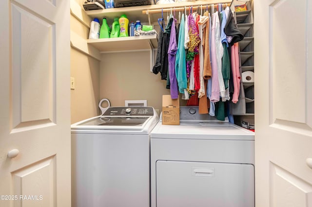 clothes washing area featuring laundry area and washer and clothes dryer