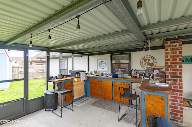 interior space featuring outdoor dry bar and fence