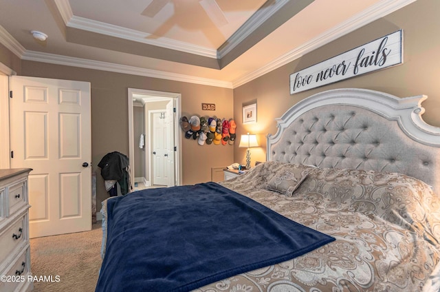 carpeted bedroom with ceiling fan, crown molding, and a tray ceiling