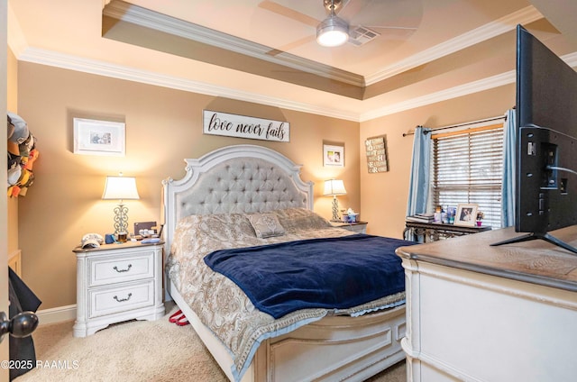 carpeted bedroom with a tray ceiling, visible vents, and ornamental molding