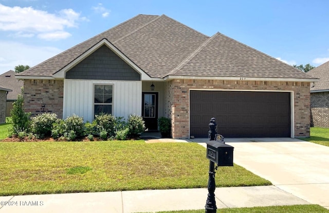 view of front facade with brick siding, a shingled roof, a front lawn, concrete driveway, and an attached garage