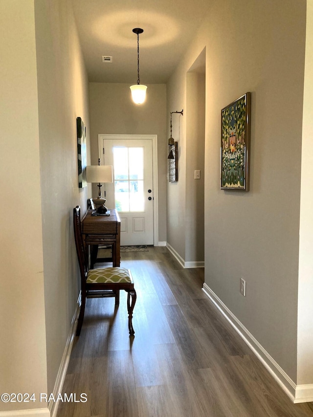 entrance foyer with dark wood-style floors and baseboards