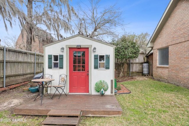 view of outdoor structure with an outbuilding and a fenced backyard