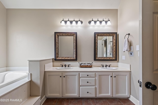 full bathroom with a bath, tile patterned floors, double vanity, and a sink