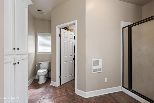 bathroom featuring tile patterned flooring, visible vents, baseboards, toilet, and a stall shower