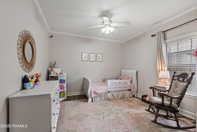 bedroom with baseboards, a ceiling fan, wood finished floors, and crown molding