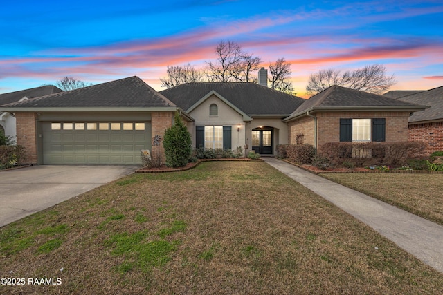 single story home featuring an attached garage, a chimney, concrete driveway, a lawn, and brick siding