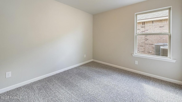 empty room featuring carpet flooring and baseboards