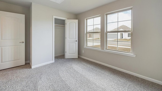 unfurnished bedroom with a closet, baseboards, and carpet