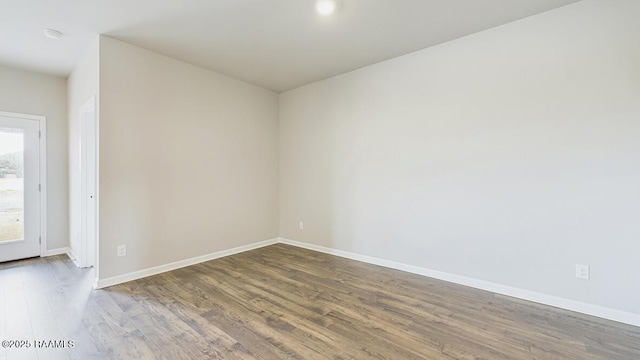 unfurnished room featuring baseboards and wood finished floors