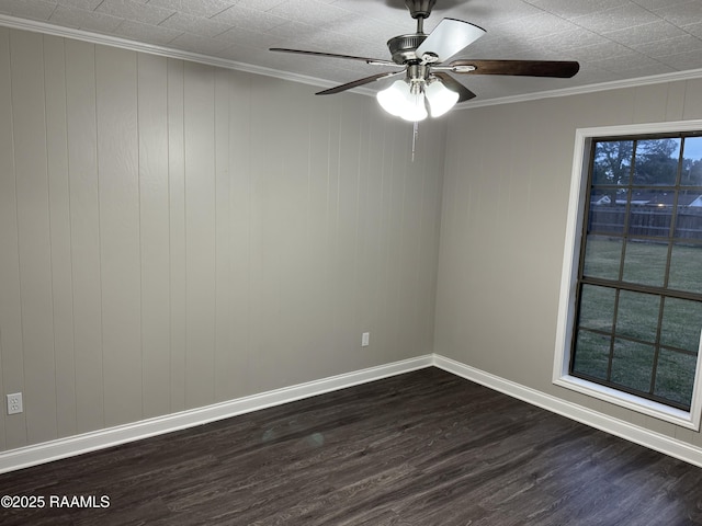 empty room with dark wood finished floors, a ceiling fan, baseboards, and ornamental molding