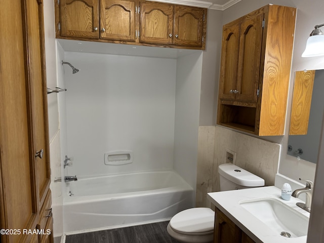 full bathroom with toilet, wood finished floors, vanity, and shower / tub combination