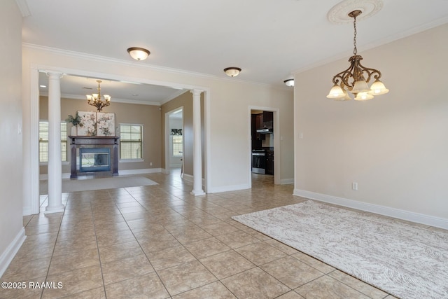 unfurnished living room with ornamental molding, a glass covered fireplace, an inviting chandelier, light tile patterned flooring, and baseboards