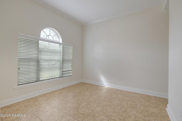 spare room with baseboards and ornamental molding