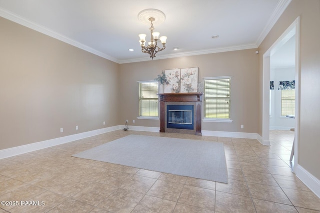 unfurnished living room with a wealth of natural light, a chandelier, and ornamental molding