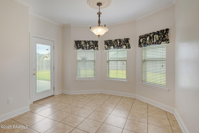 spare room with light tile patterned floors, baseboards, and ornamental molding