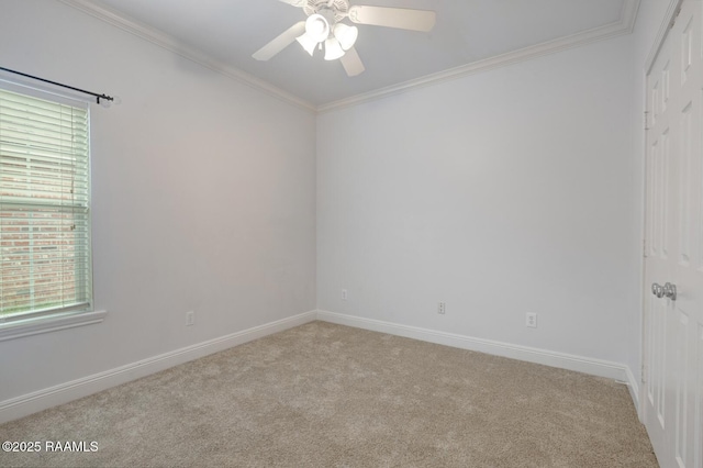 unfurnished room with baseboards, a ceiling fan, crown molding, and carpet