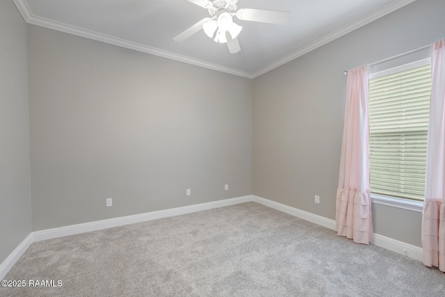 carpeted empty room with crown molding, baseboards, and ceiling fan