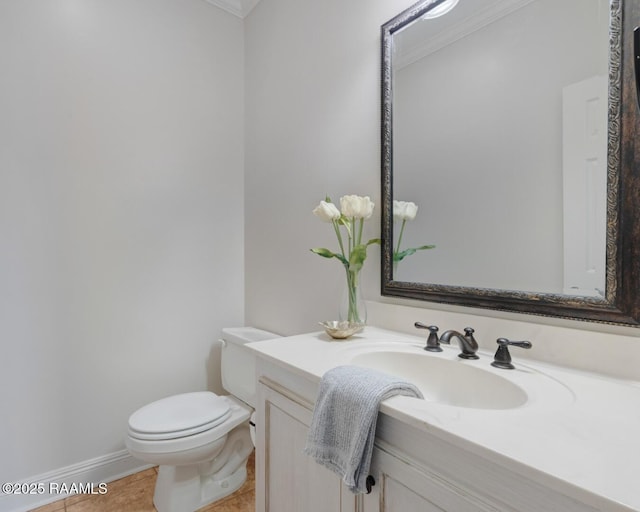 bathroom with tile patterned floors, baseboards, toilet, and vanity