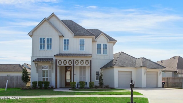 view of front of property featuring concrete driveway, an attached garage, fence, and board and batten siding