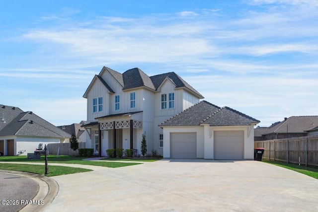 modern inspired farmhouse with fence, board and batten siding, concrete driveway, a front yard, and a garage