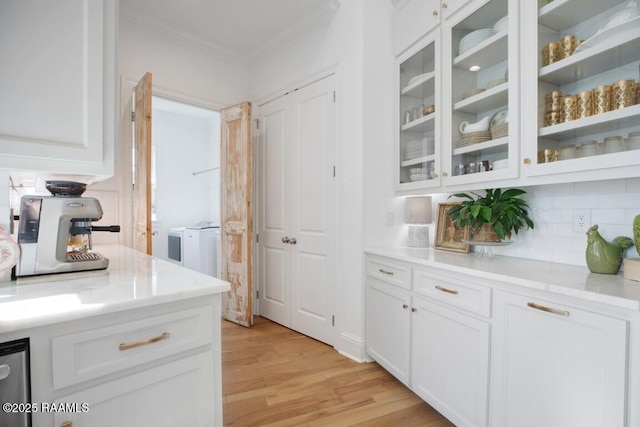 kitchen with white cabinetry, crown molding, glass insert cabinets, and light wood-style floors